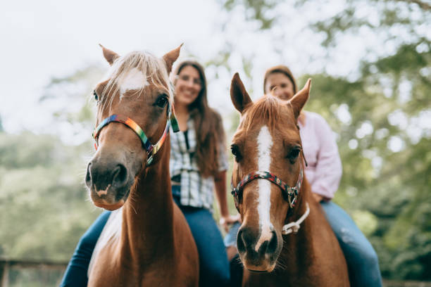 Mother and daughter on horseback